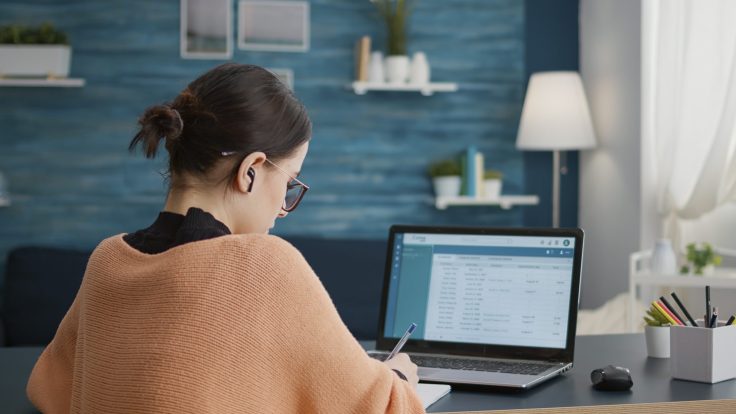 Student working form home on laptop to do internet research